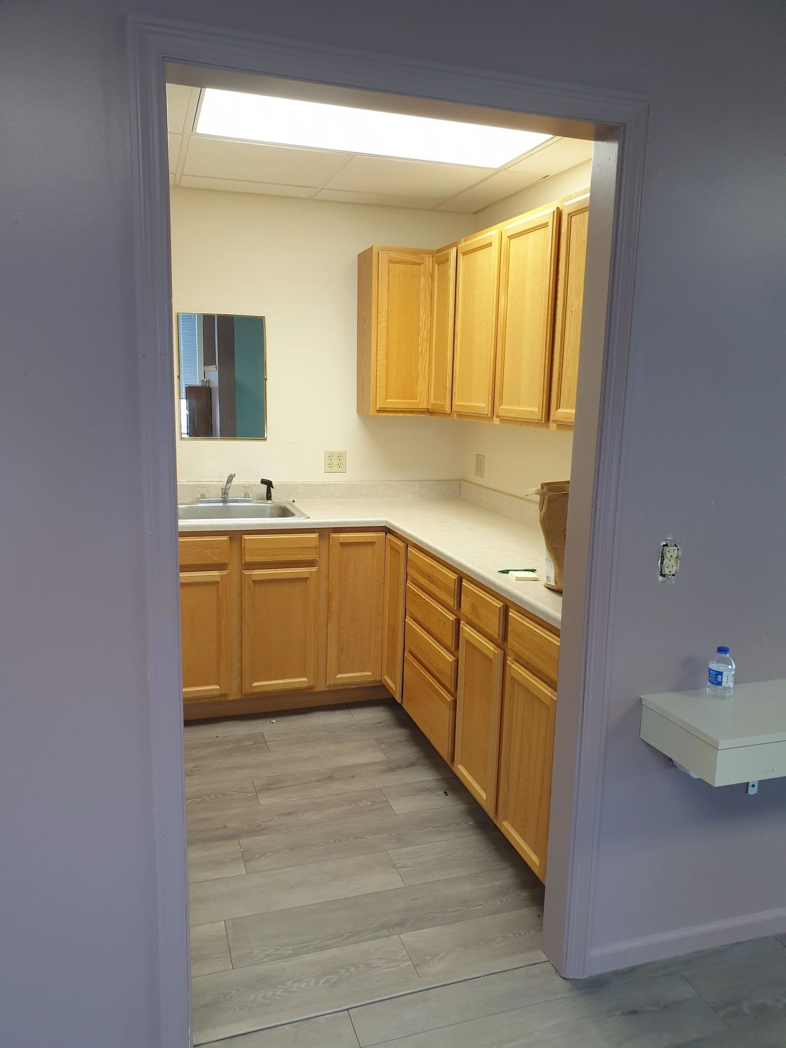 Kitchenette with cabinetry and sink inside 302 Chestnut
